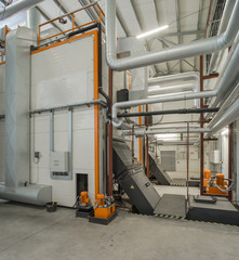 Modern boiler room on the wooden chips.