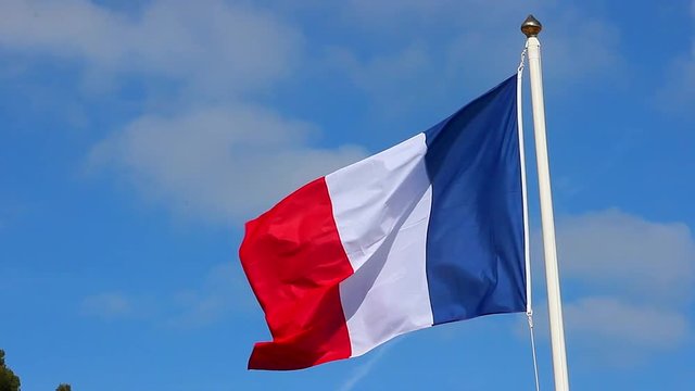 French Flag Waving Over A Blue Cloudy Sky