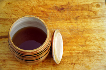 barrel of honey on a wooden table