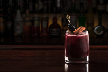 Blackberry cocktail with cinnamon stick.