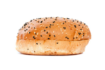 Burger bun with sesame seeds on white background