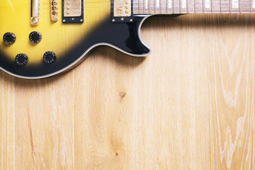 Horizontal guitar on wooden surface