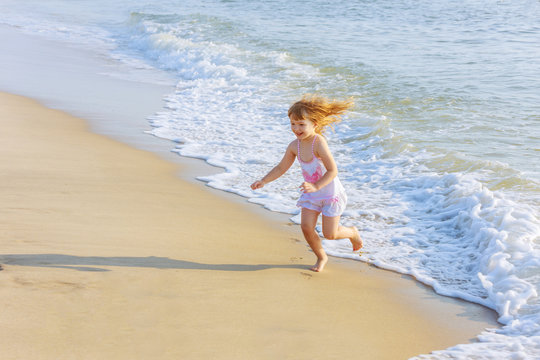 Little girl playing in the ocean