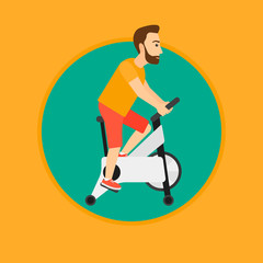 Man riding stationary bicycle.