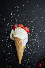 icecream cone with strawberry and pistachio nuts
