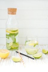 Homemade lemonade with a lime, a lemon and mint
