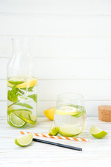 Homemade lemonade with a lime, a lemon and mint
