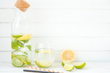 Homemade lemonade with a lime, a lemon and mint
