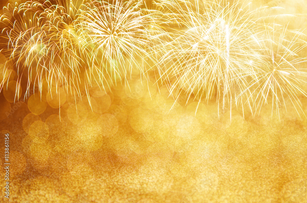 Wall mural defocused gold fireworks and bokeh at new year and copy space. abstract background holiday.