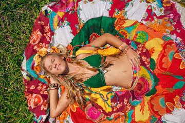 boho style woman lying on the grass