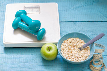 Fitness and diet abstract concept with dumbbells
