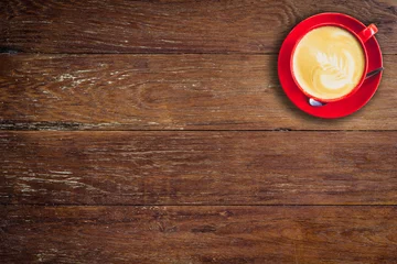 Fotobehang red coffee cup on old wood background with space. © tortoon