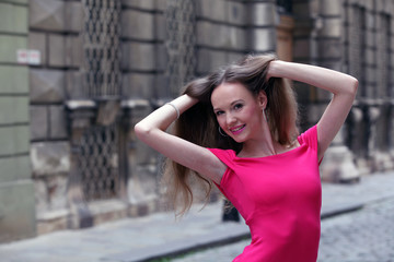 Fashionable young woman in pink dress