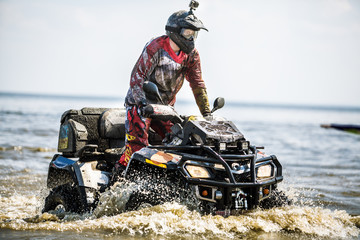 Travel on ATVs in river.ATV in action, having fun with sport.The