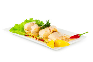 Dish of fish with greens and lemon isolated