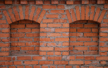 Fototapeta na wymiar Fragment of the old red brick wall