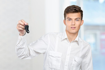 Young smiling man holding car keys