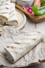 burrito on parchment with vegetables
