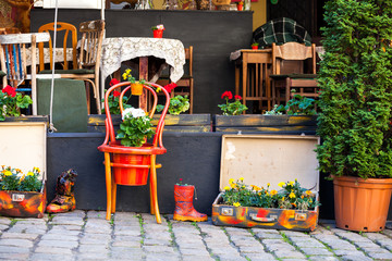 Fototapeta na wymiar Street cafe terrace with tables and flowers in European city