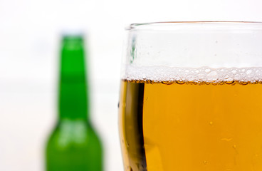 glass of beer with foam on a white background