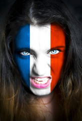 Portrait of a woman with the flag of the France  painted on her face