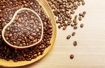 cups with fresh roasted coffee on wood