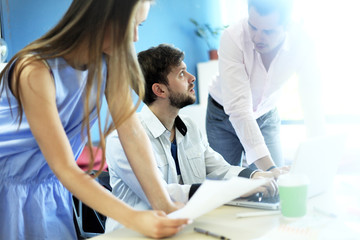 Obraz premium Young professionals work in modern office. Blurred,sunlights