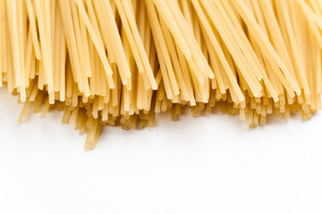 Raw spaghetti on white background.
