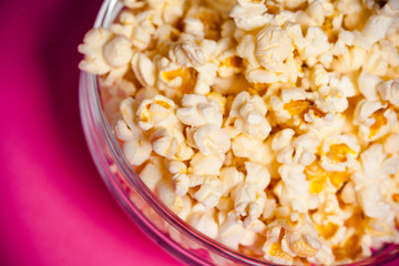 bowl with popcorn on red background