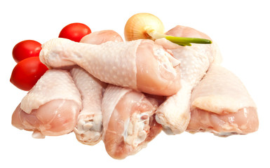 Raw chicken legs with vegetables, isolated on white background