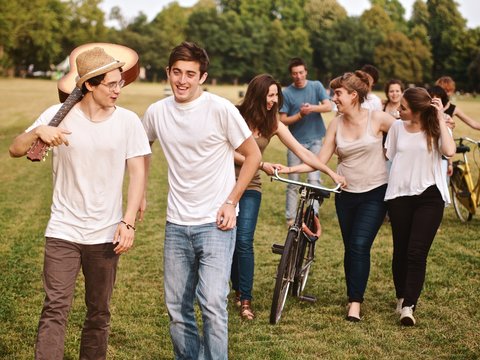 large group of friends together in a park having fun, back to school