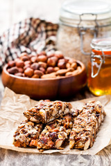 Healthy  protein granola bars with seeds and nuts on wooden back