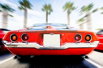 Foto op Canvas Achteraanzicht van klassieke 1972 Chevrolet Camaro in oranje kleur, in beweging. te hard rijden. © daviles