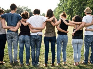 large group of friends together in a park having fun