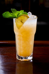 Tropical yellow cocktail with fresh mint.