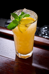 Tropical yellow cocktail with fresh mint.