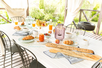 Summer outdoor continental breakfast on the garden terrace