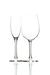 Two empty wine glasses on white