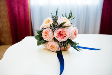 Bridal bouquet of pink roses with blue ribbon