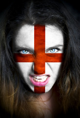 Portrait of a woman with the flag of the England  painted on her face