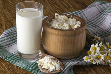 Cottage cheese, glass with milk and chamomile flowers