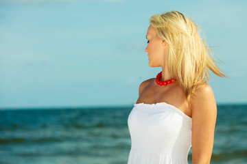 Fototapeta na wymiar Young lady on sunny beach.