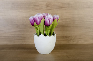 Tulip flowers against wooden background
