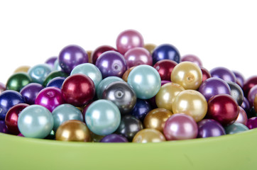 Pearls in the bowl isolated on white background