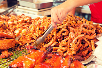 close up of cook hands and snacks at street market