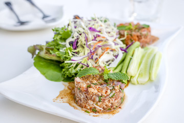 Spicy pork salad with vegetables and chillies what we called Larb Moo in Thai style local the northeastern delicious food of Thailand.