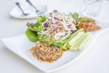 Hot and spicy seafood salad shrimp, salmon vegetables and chillies in Thai what we called Larb Talay  local style the northeastern delicious food of Thailand.