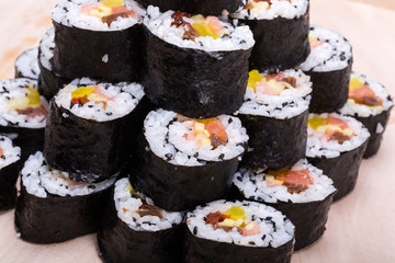  sushi fresh maki rolls isolated on wooden board