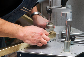 Craftsman working on frame in frameshop.