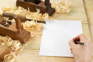 White sheet on wooden table for carpenter tools with sawdust.